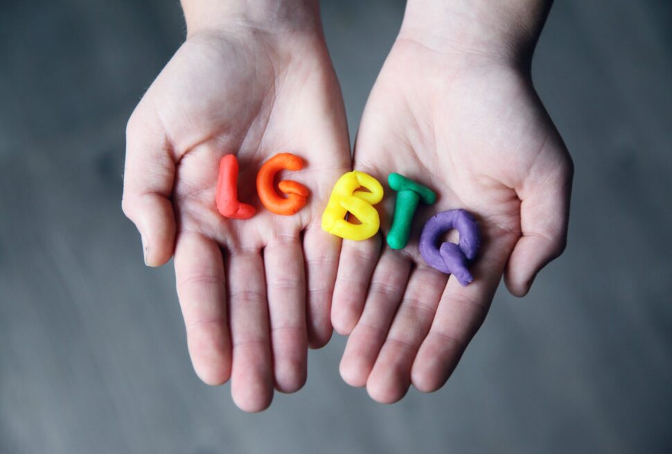 close up photo of lgbtq letters on a person s hands